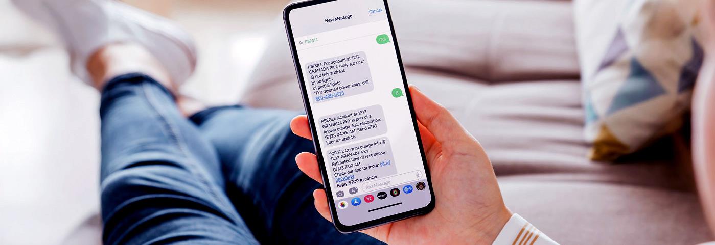 Female executive on a street looking at her smartphone