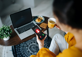 Scattered Scrabble tiles on a table surrounding the spelt out word "Scam"