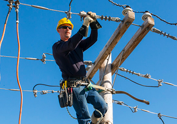 A utility worker working on power lines