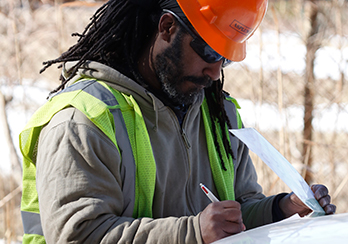 PSEG Long Island technician writing notes on a clipboard