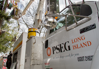 Group of adults standing next to young Boy Scout who's holding a plaque
