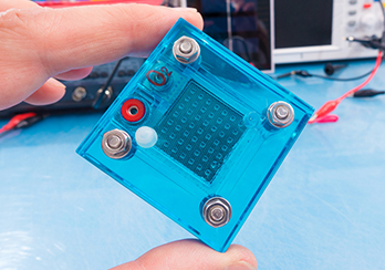 Fingers holding a solar component