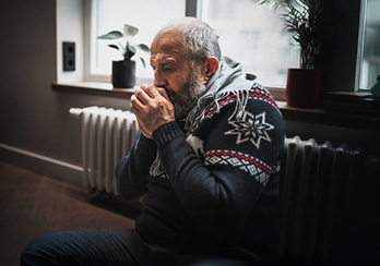 a father, mother, and young child in front of a house