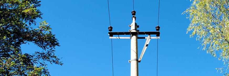 Overhead power lines against a blue sky