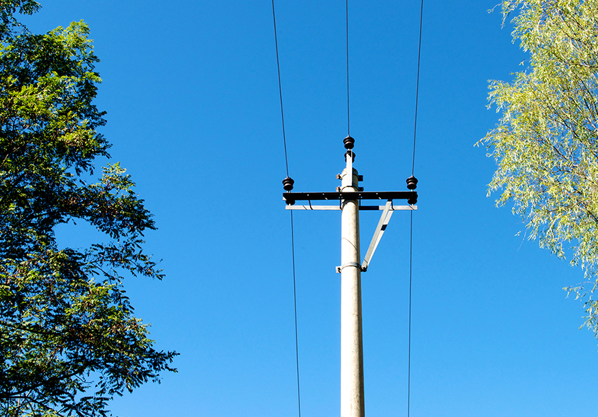 Overhead power lines against a blue sky