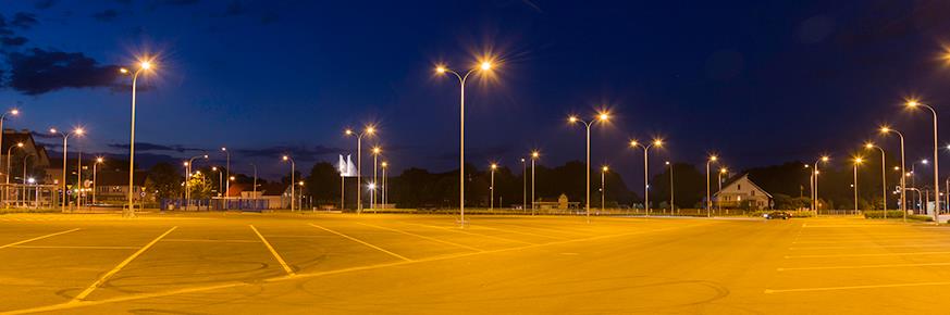 A large parking lot illuminated by streetlights