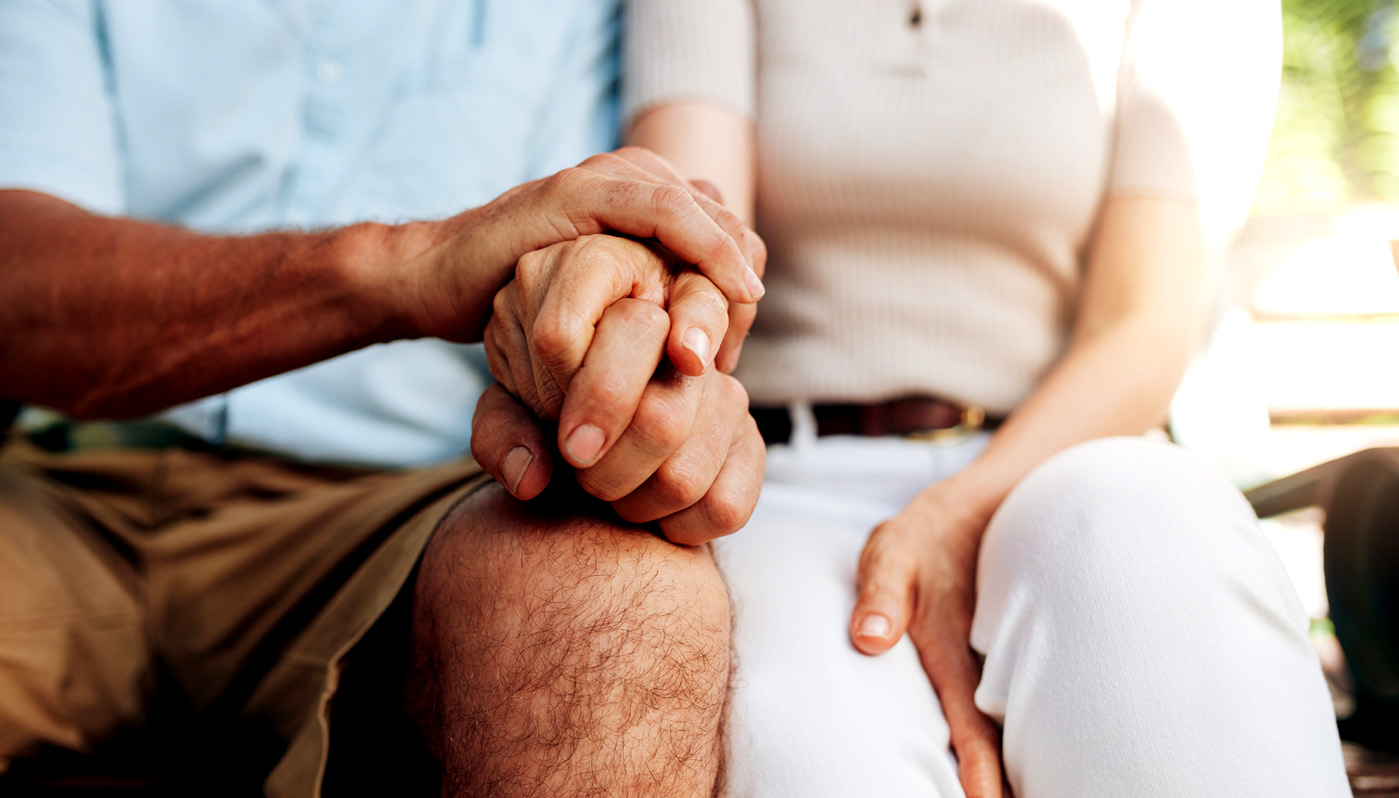 senior couple holding hands