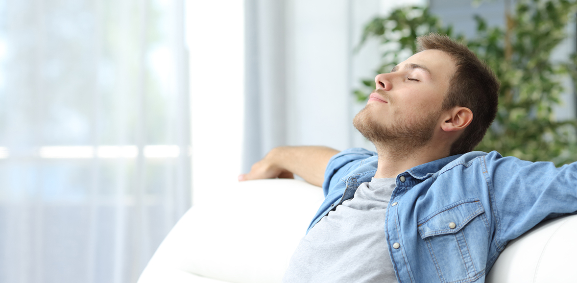 man relaxing on couch