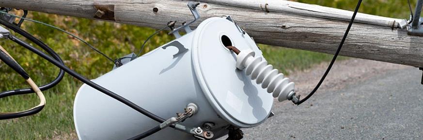 Transmission towers and power lines at sunset