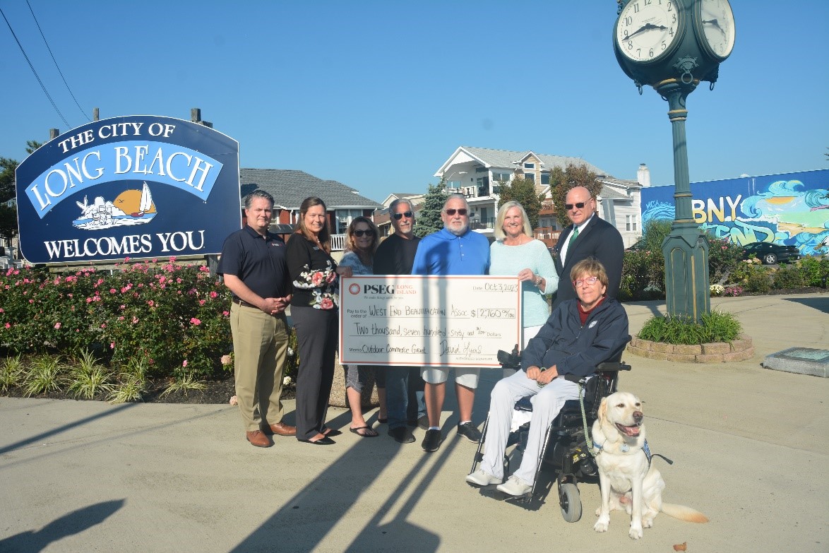 Pictured (from l-r) are: Christopher Chaffee and Linda Herman of PSEG Long Island; Robin Terzi, a local realtor; Larry Cerullo of Cerullo Landscaping; Barry Koff, son of Irwin Koff for whom the park is named; Mary Ellen Pollina, founder and co-director of the West End Beautification Association; Ron Walsh, Long Beach police commissioner/acting city manager; and Liz Treston, vice president of the Long Beach City Council with Macgyver. 
