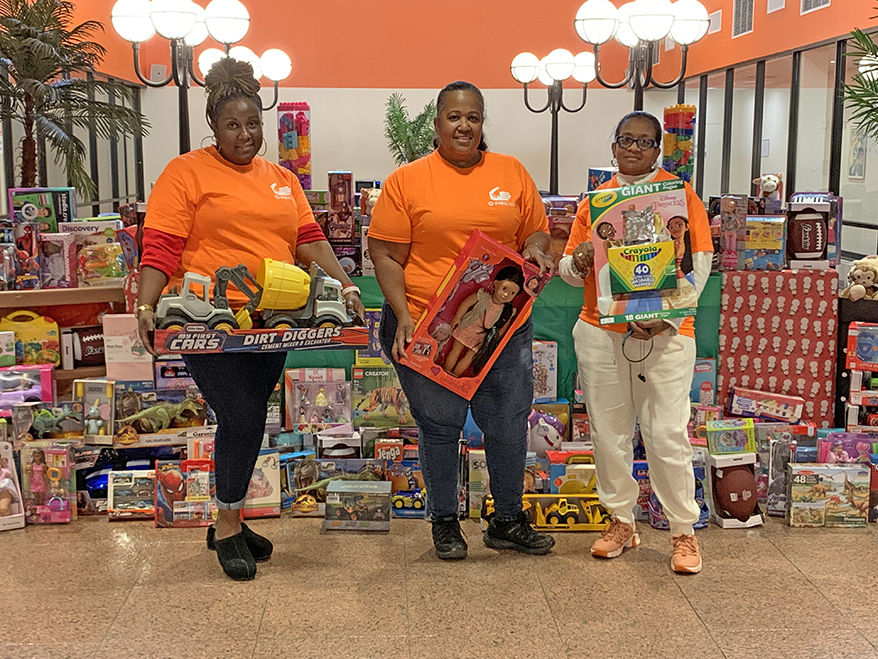 Left to right: PSEG Long Island Employees Sherma Pollard, Tonya Simmons and Belinda Cox stand with toys collected as part of the company's annual holiday toy drive.