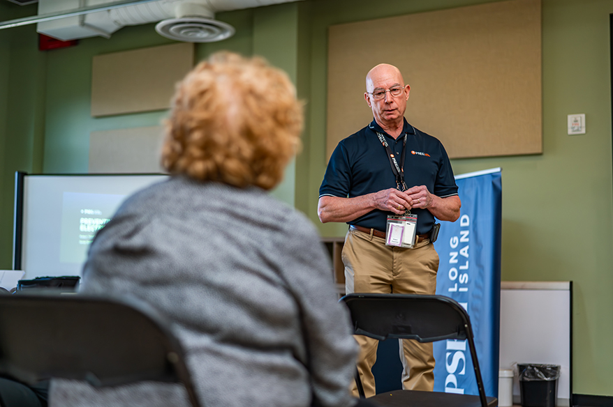Robert Vessichelli, lead investigator with PSEG Long Island Corporate Security, educates seniors in Huntington about common utility scams in February 2025.