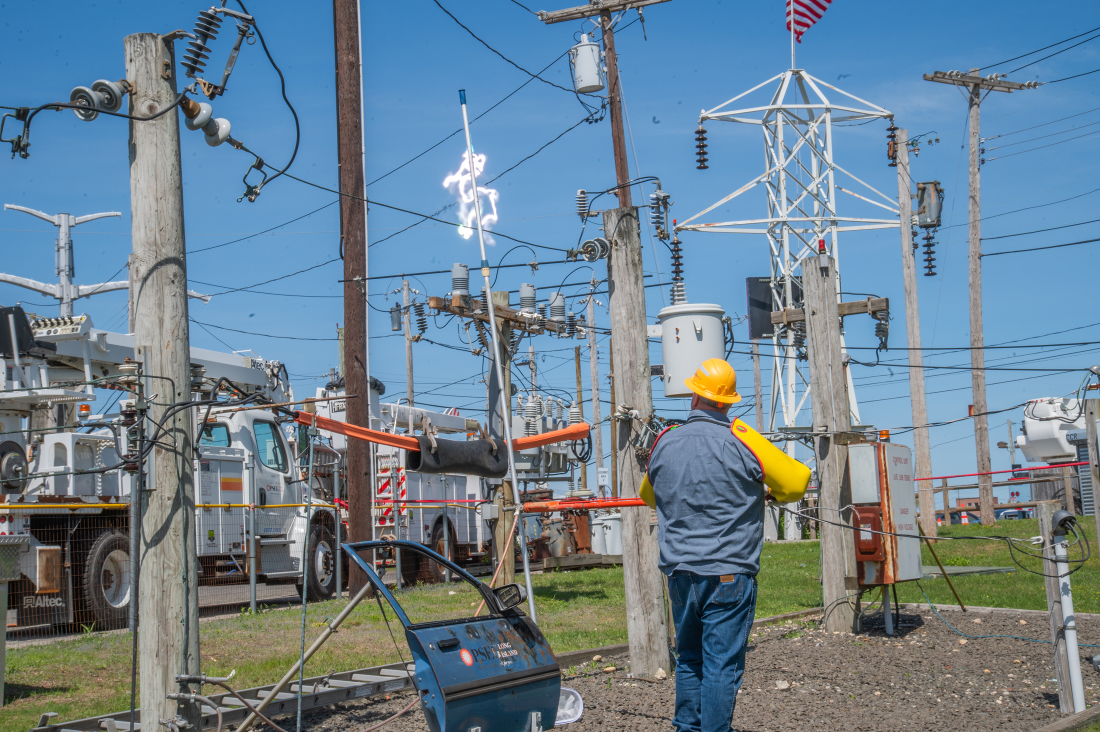 A PSEG Long Island employee demonstrates the flow of electricity that can occur when a metal pool skimmer comes into contact with overhead electric lines at the company's training academy in Hicksville.