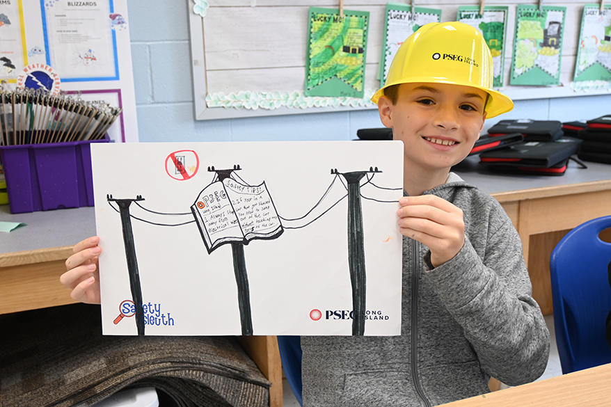 Fifth grader Jackson Beanland and his classmates in Cara Stern’s class at Paul J. Bellew Elementary School in West Islip create posters for PSEG Long Island’s Safety Sleuth program.