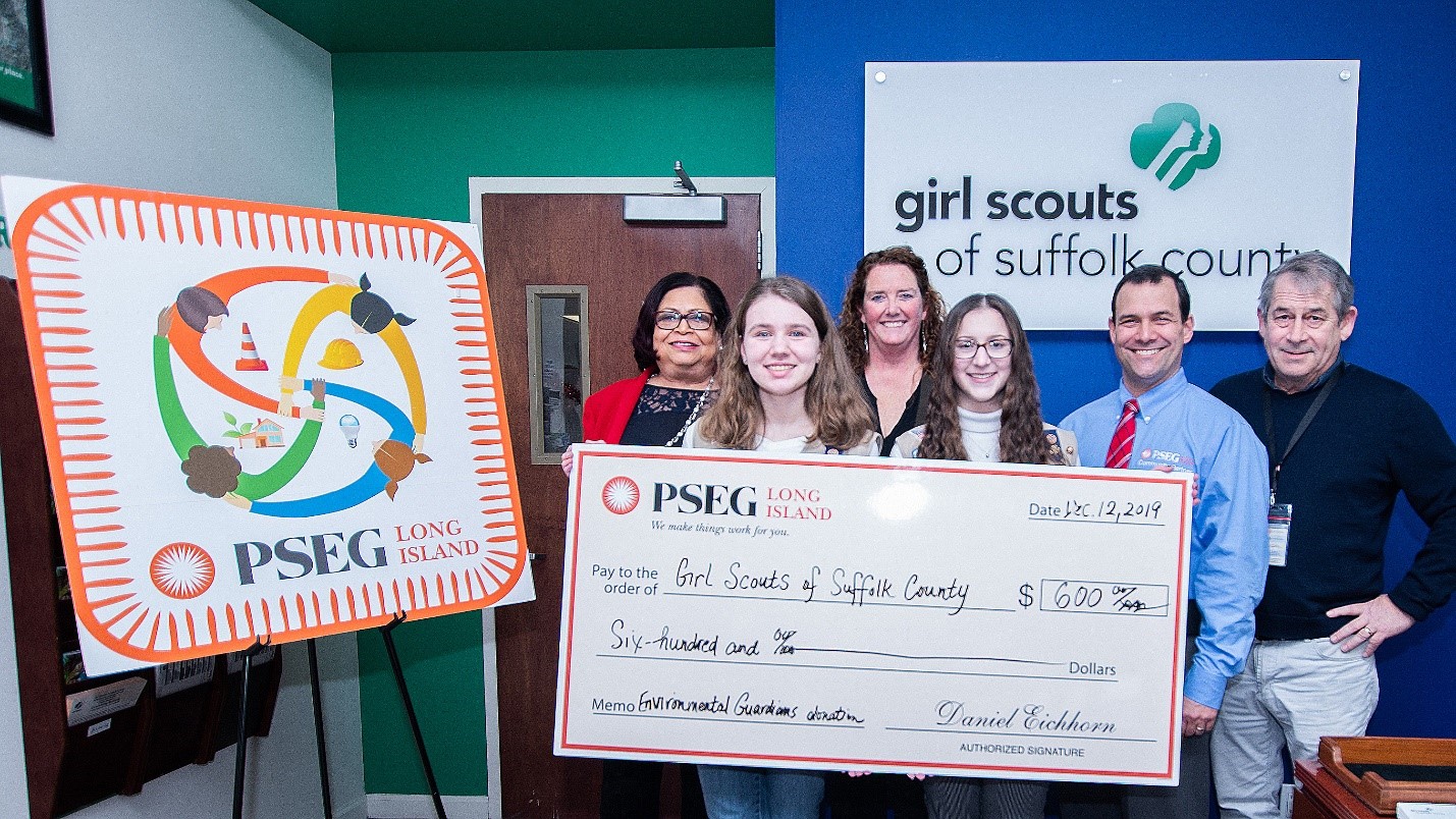 Suffolk County Girl Scout Hailey Van Cott (right, foreground), of Stony Brook, received $200 from PSEG Long Island to help complete her Gold Award project to help rehabilitate injured birds of prey. She is joined by (l. to r.) Yvonne Grant, president of the Suffolk County Girl Scouts; Elizabeth Flagler of PSEG Long Island; fellow Girl Scout Caroline Hines; and Brian Kurtz and Pete Hornick of PSEG Long Island.