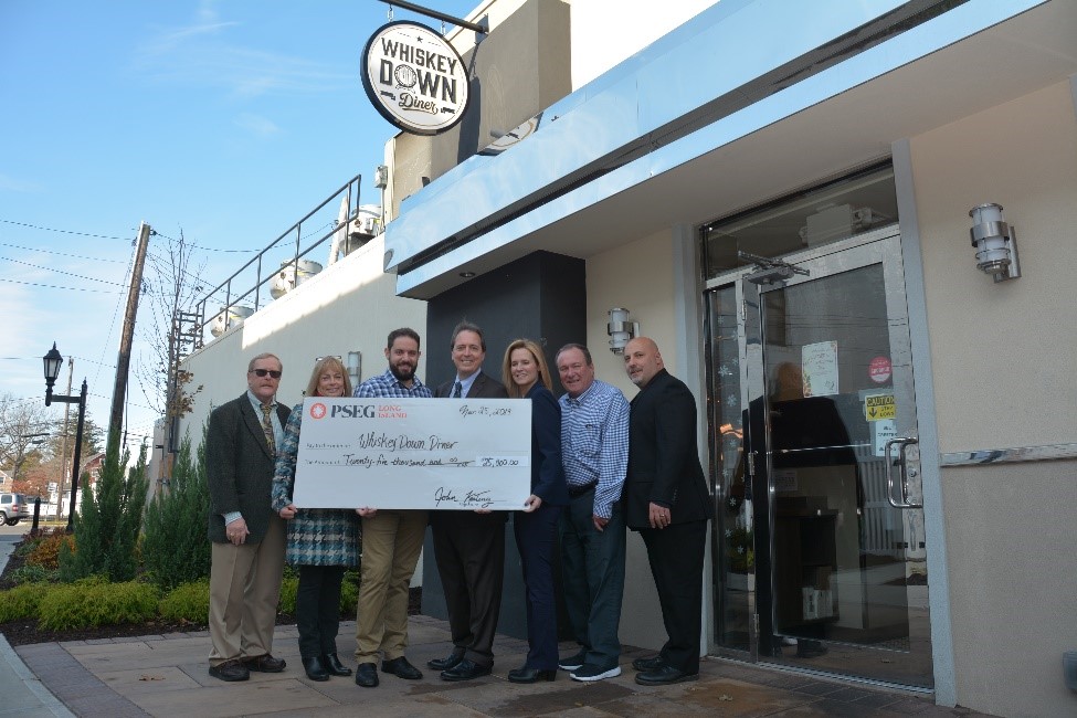 Pictured (L to R) in the courtyard of Farmingdale’s new Whiskey Down Diner are: Ralph Ekstrand, Farmingdale Village mayor; Cheryl Parisi, Farmingdale Village trustee; John Kanaras, Whiskey Down Diner owner; PSEG Long Island’s Economic Development Manager John Keating, Regional External Affairs Manager Kim Kaiman and Economic Development Consultant Tim Harris; and Eric Alexander, Vision Long Island director.