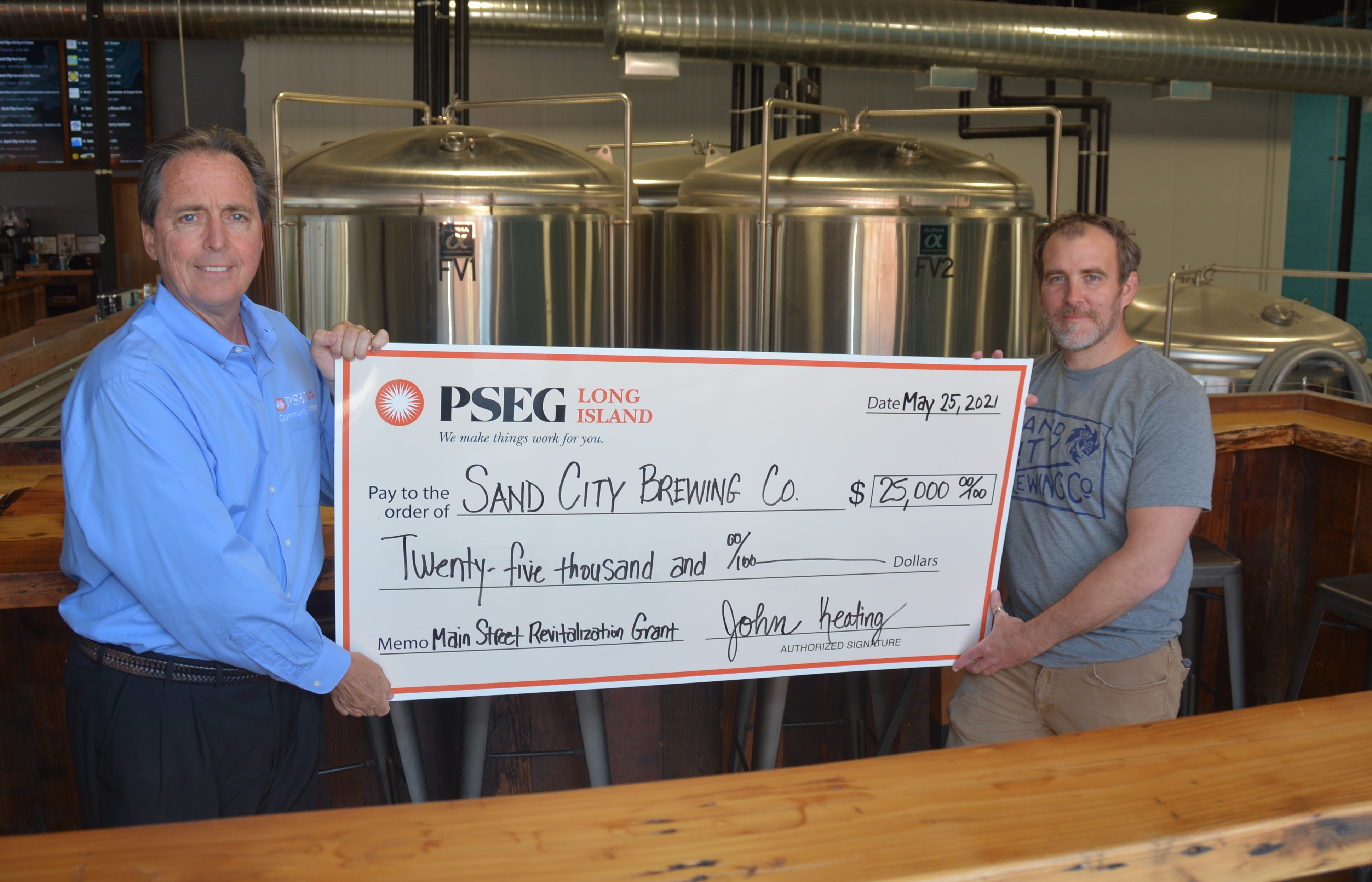 Pictured from left to right are John Keating, manager of Economic Development at PSEG Long Island and Bill Kiernan, co-owner of Sand City Brewing Co.  