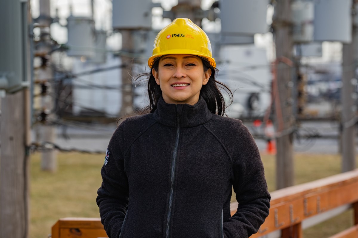 PSEG Long Island employee Paola Moreno stands wearing a hard hat.