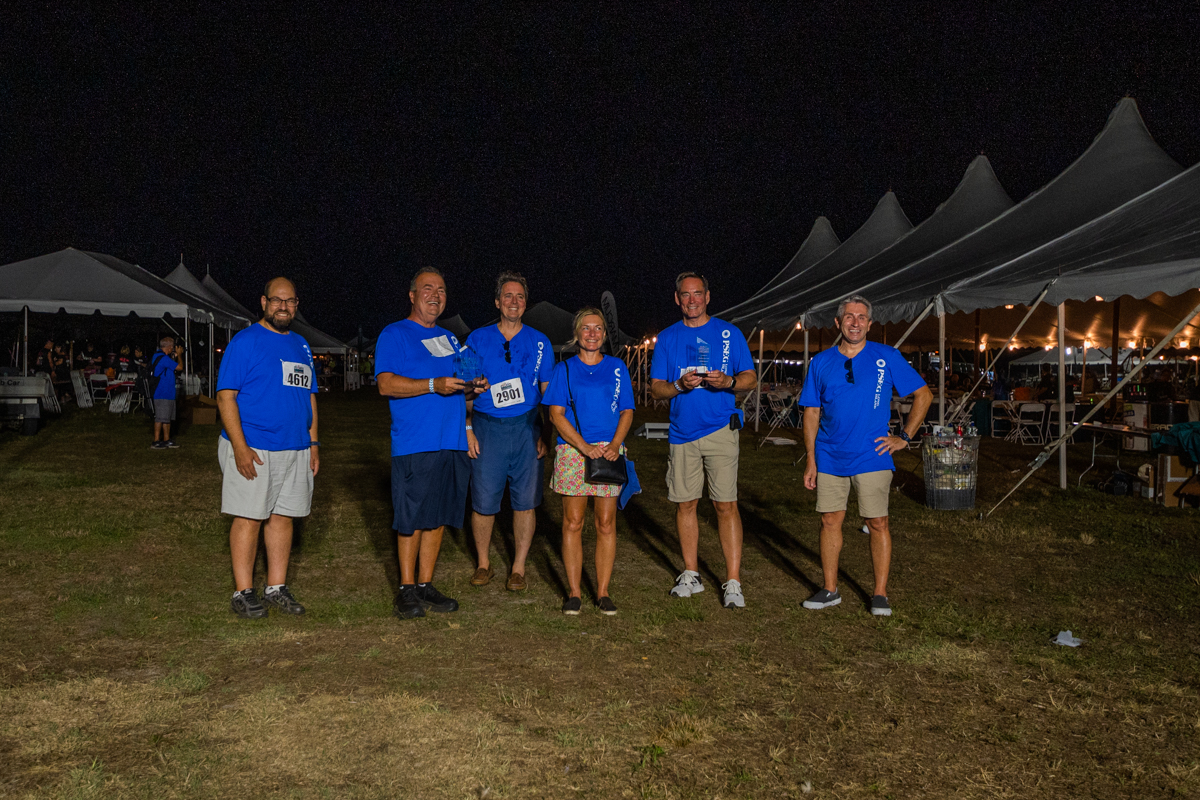 Pictured (l-r) James Tsivitis, George Coburn, John Keating, Debbie Mullarkey, David Lyons (interim president and COO) and Louis DeBrino, of PSEG Long Island with the two awards the company received for its fundraising efforts to support the Marcum Workplace Challenge.